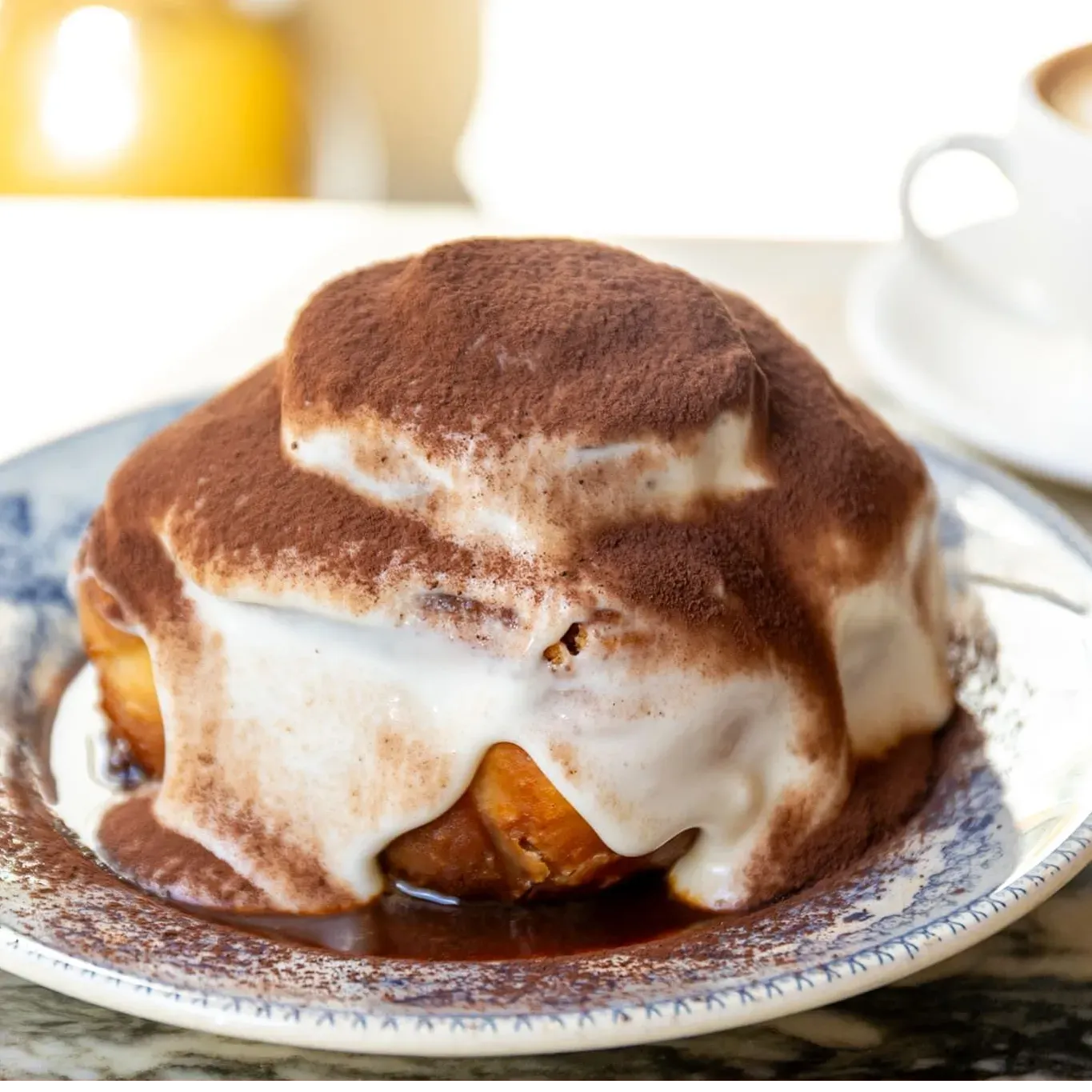 Tiramisu cinnamon roll with cocoa dust